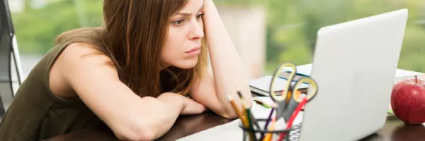 woman staring at a laptop computer