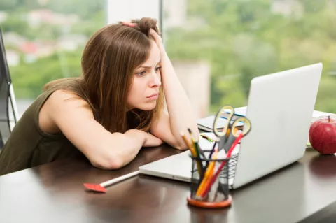woman staring at a laptop computer